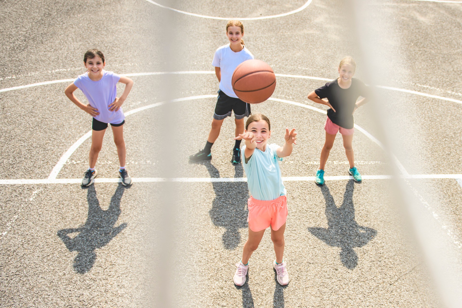Childs girls Team in sportswear playing basketball game