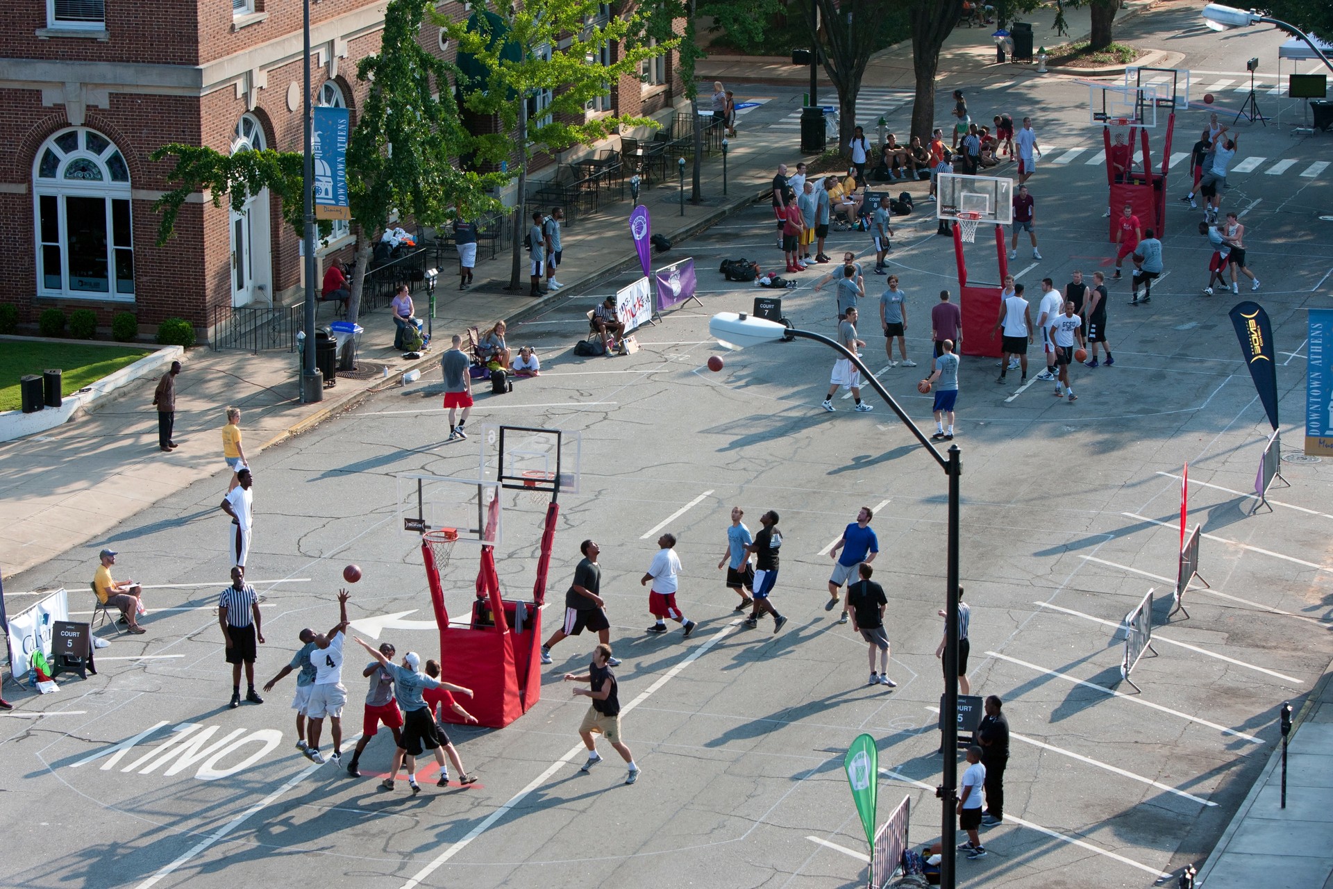 Men Play In Outdoor Basketball Tournament On City Street